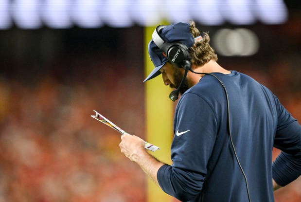 Offensive coordinator Davis Webb of the Denver Broncos looks at his play sheet during the third quarter against the Kansas City Chiefs at Arrowhead Stadium in Kansas City, Missouri on Monday, September 14, 2026. (Photo by AAron Ontiveroz/The Denver Post)