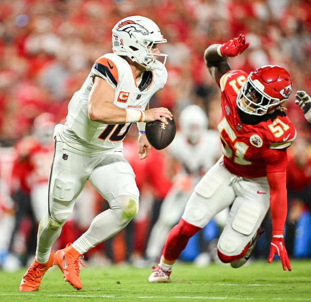 Bo Nix (10) of the Denver Broncos scrambles as R. Mason Thomas (51) of the Kansas City Chiefs pursues during the second quarter at Arrowhead Stadium in Kansas City, Missouri on Monday, September 14, 2026. (Photo by AAron Ontiveroz/The Denver Post)
