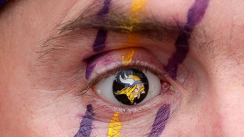 Vikings fan Brian Foss displays his custom Minnesota Vikings logo prosthetic eye at a fan event.