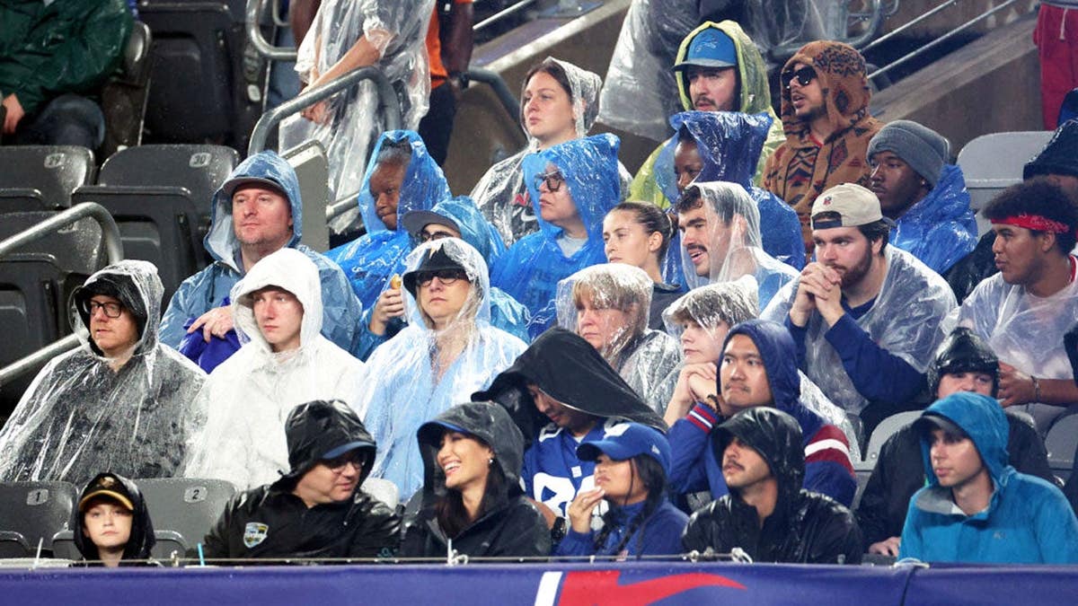 New York Giants fans sit in the rain at MetLife Stadium.