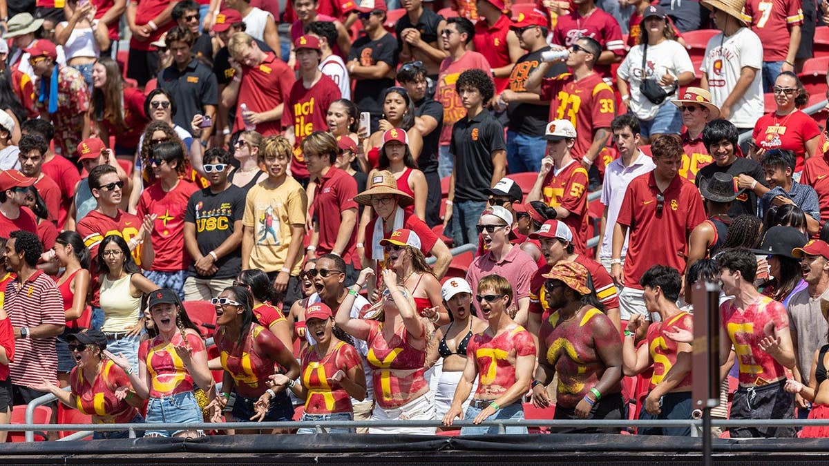 USC fans in the student section cheer during a football game at the Los Angeles Memorial Coliseum.