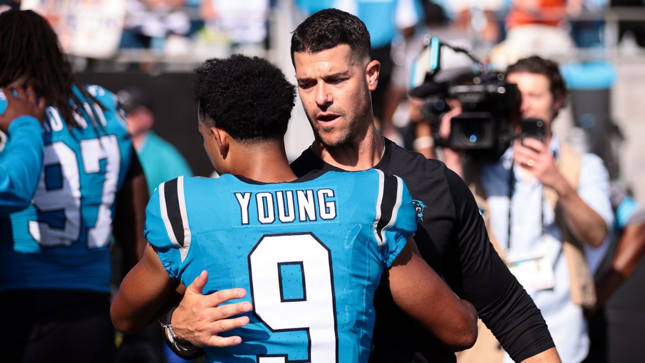 Carolina Panthers head coach Dave Canales embraces quarterback Bryce Young (9) after an NFL football game Sunday, Sept. 13, 2026, in Charlotte, N.C. (AP Photo/Scott Kinser)