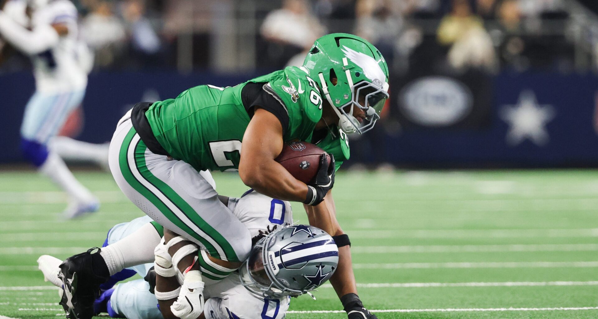 Nov 23, 2025; Arlington, Texas, USA; Philadelphia Eagles running back Saquon Barkley (26) is brought down by Dallas Cowboys linebacker DeMarvion Overshown (0) in the fourth quarter at AT&T Stadium.