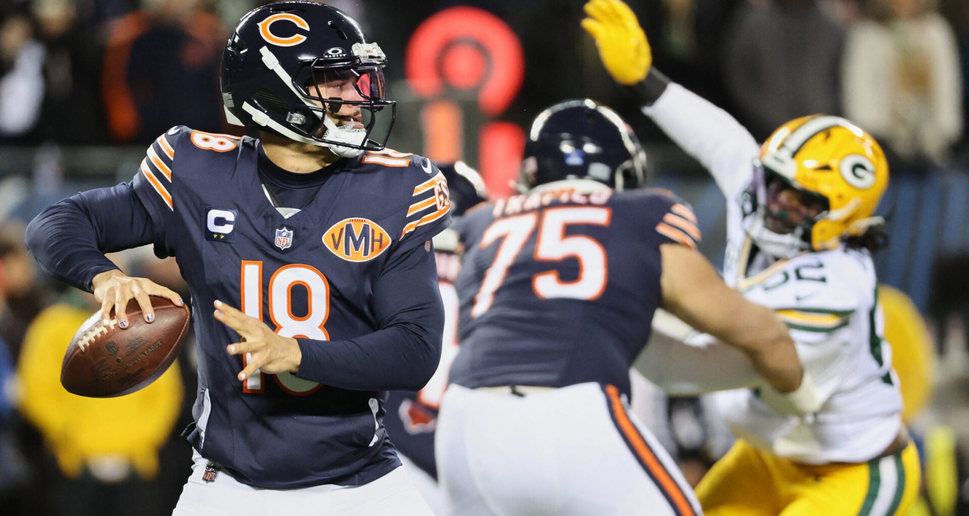 Dec 20, 2025; Chicago, Illinois, USA; Chicago Bears quarterback Caleb Williams (18) prepares to throw a pass and offensive tackle Ozzy Trapilo (75) blocks against Green Bay Packers defensive end Rashan Gary (52) during the first quarter at Soldier Field.
