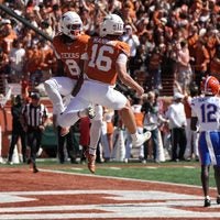 Oct 17, 2026; Austin, Texas, USA; Texas Longhorns wide receiver Cam Coleman (8) and quarterback Arch Manning (16) react after Coleman caught a touchdown pass from Manning during the second half against the Florida Gators at Darrell K Royal-Texas Memorial Stadium.
