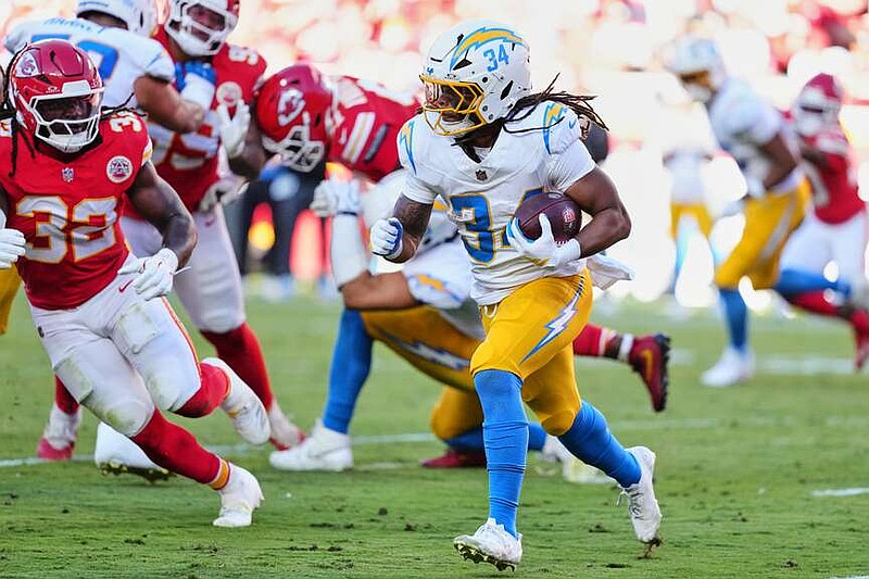 Los Angeles Chargers running back Keaton Mitchell (34) runs the ball as Kansas City Chiefs linebacker Nick Bolton (32) gives chase during the first half of an NFL football game in Kansas City, Mo., Sunday, Oct. 18, 2026. (AP Photo/Ed Zurga)