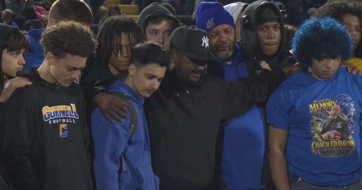 Cornell school community honors football coach Ed Dawson at candlelight vigil