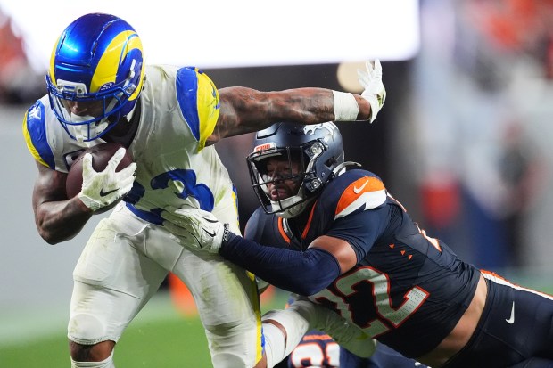 Los Angeles Rams running back Kyren Williams, left, is stopped by Denver Broncos safety Brandon Jones during the second half of an NFL football game Sunday, Sept. 27, 2026, in Denver. (AP Photo/David Zalubowski)