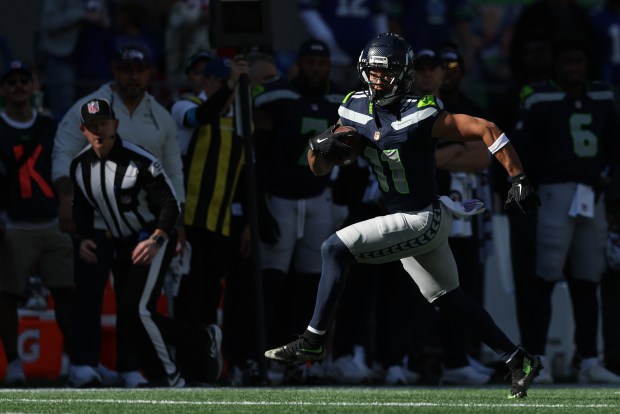 Jaxon Smith-Njigba #11 of the Seattle Seahawks carries the ball after a reception against the San Francisco 49ers during the second quarter at Lumen Field on October 11, 2026 in Seattle, Washington. (Photo by Steph Chambers/Getty Images)