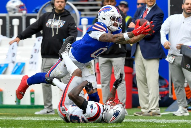 Buffalo Bills wide receiver Keon Coleman (0) catches a pass over New England Patriots cornerback Kindle Vildor (28) during the second half of an NFL football game in Orchard Park, N.Y., Sunday, Oct. 4, 2026. (AP Photo/Adrian Kraus)