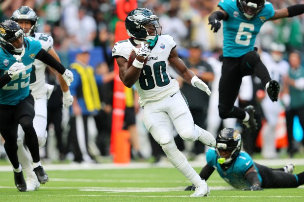 Philadelphia Eagles wide receiver Darius Cooper (80) scores a touchdown against the Jacksonville Jaguars during the first half of an NFL football game in London, Sunday, Oct. 11, 2026. (AP Photo/Adam Bettcher)