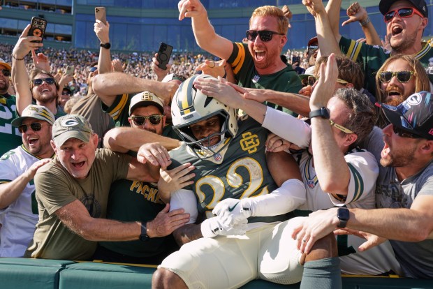 Green Bay Packers' Marshawn Lloyd celebrates his touchdown run with fans during the second half of an NFL football game against the Chicago Bears in Green Bay, Wis., Sunday, Oct. 11, 2026. (AP Photo/Mike Roemer)