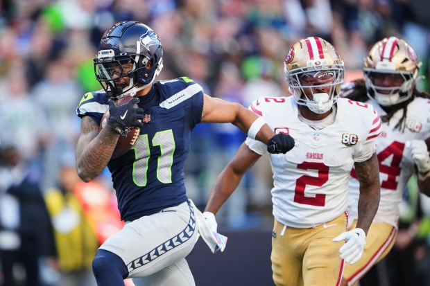 Seattle Seahawks wide receiver Jaxon Smith-Njigba (11) runs past San Francisco 49ers cornerback Deommodore Lenoir (2) on his way to score on a catch during the second half of an NFL football game Sunday, Oct. 11, 2026, in Seattle. (AP Photo/Lindsey Wasson)