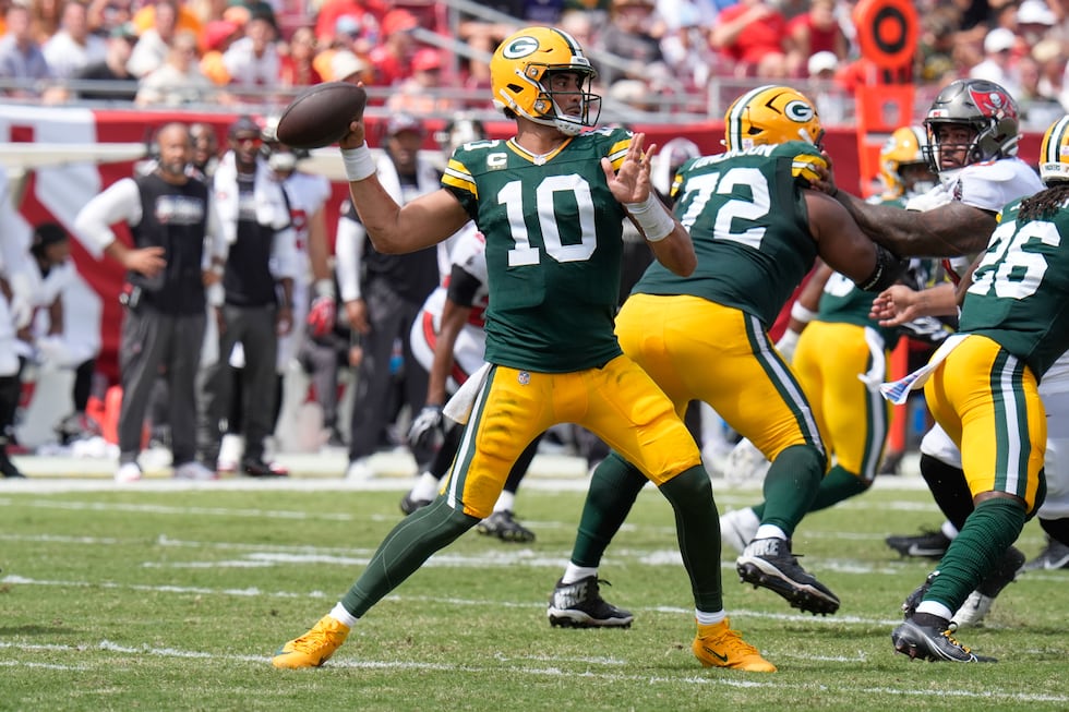 Green Bay Packers quarterback Jordan Love (10) aims a pass during an NFL football game against...