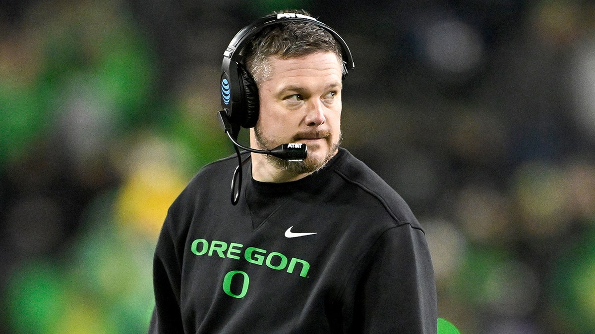Dan Lanning looks on