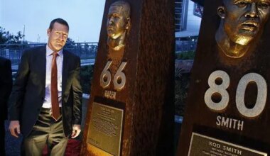 Former Denver Broncos center Tom Nalen stands in front of a pillar bearing his likeness, alongside those for fellow Bronco greats, at the unveiling ceremony for the Broncos Ring of Fame Plaza, at Mile High Stadium on Friday Sept. 27, 2013, in Denver. Nalen is to be inducted into Ring of Fame this weekend. (AP Photo/Brennan Linsley)
