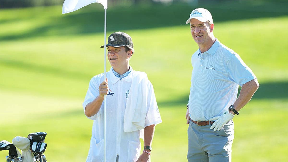 Peyton Manning stands with his son Marshall Manning at Muirfield Village Golf Club.