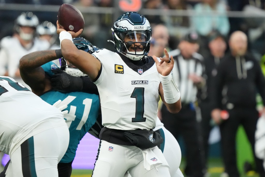 Philadelphia Eagles quarterback Jalen Hurts prepares to throw a pass under pressure during a game against the Jacksonville Jaguars.