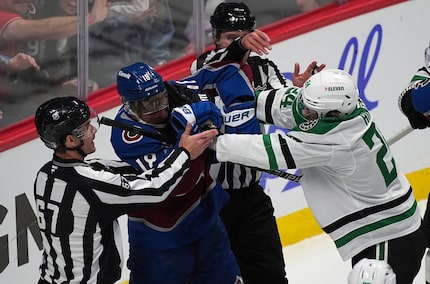 Colorado Avalanche center Jack Drury, left, tussles with Dallas Stars center Roope Hintz in...