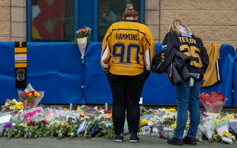 Ice hockey fans lay floral tributes to Adam Johnson at the Motorpoint Arena in Nottingham