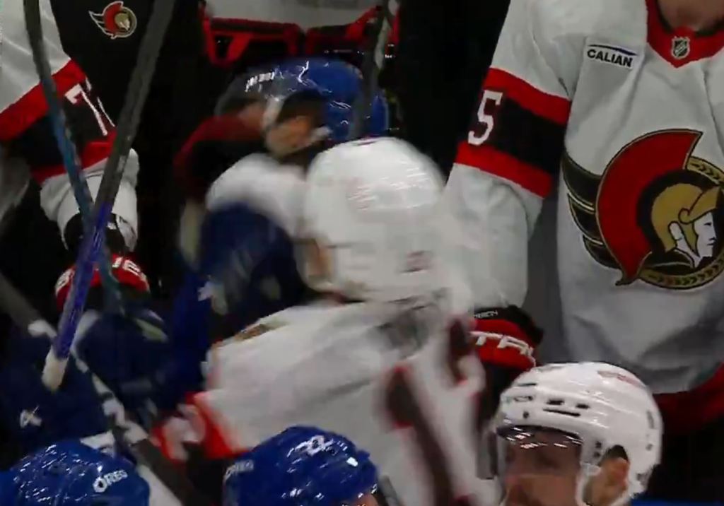 Ottawa's Shane Pinto (12) punches Toronto's Chris Tanev (8) on April 20, 2025.