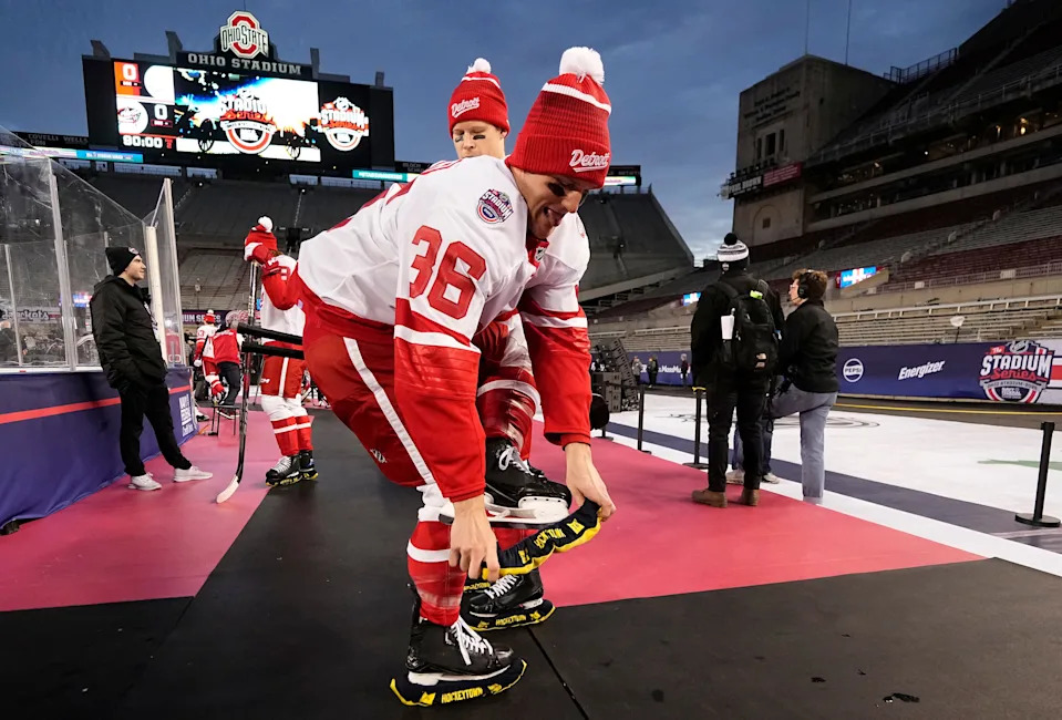 Detroit Red Wings right wing Christian Fischer (36) puts on maize and blue skate protectors before practice at Ohio Stadium in preparation for the NHL Stadium Series game against the Columbus Blue Jackets on Friday, Feb. 28, 2025.