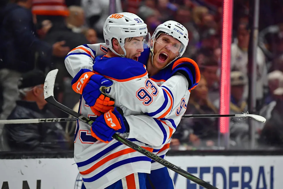 Edmonton Oilers center Ryan Nugent-Hopkins (93) celebrates with Connor McDavid (97) after scoring an empty-net goal against the Los Angeles Kings.Gary A&period; Vasquez-Imagn Images