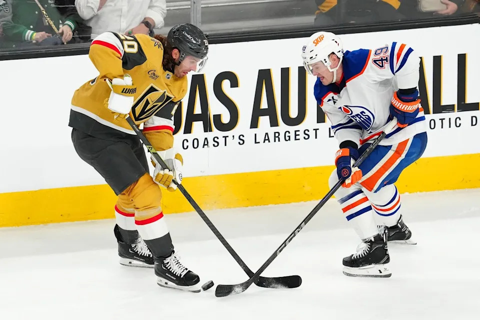 Edmonton Oilers defenseman Ty Emberson (49) tips the puck away from Vegas Golden Knights left wing Brandon Saad (20) during the third period at T-Mobile Arena.Stephen R&period; Sylvanie-Imagn Images