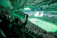 Fans stand and cheer as the Dallas Stars take the ice before Game 5 of an NHL hockey Stanley...