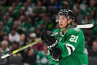 Dallas Stars left wing Jason Robertson adjusts his gear before a face off during the first...