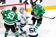 Dallas Stars left wing Jamie Benn (14) looks at the puck before knocking it past Utah Hockey...