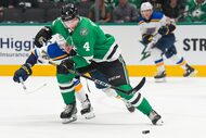 Dallas Stars defenseman Miro Heiskanen (4) fights for the puck against St. Louis Blues...
