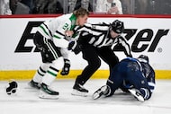 Linesman Devin Berg (87) gets between Dallas Stars' Roope Hintz (24) and Winnipeg Jets'...