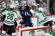 Dallas Stars' Thomas Harley (55) checks Winnipeg Jets' Nikolaj Ehlers (27) during the third...