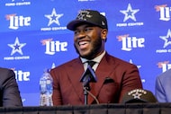Dallas Cowboys first-round NFL football draft pick Tyler Booker laughs during a news...