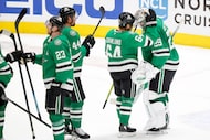 Dallas Stars goaltender Jake Oettinger (29) and center Mikael Granlund (64) congratulate one...