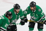 Dallas Stars left wing Jamie Benn (14) talks with center Tyler Seguin (91) and left wing...