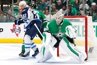 Dallas Stars goaltender Jake Oettinger (29) defends the goal against the Winnipeg Jets...