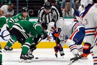 Dallas Stars center Sam Steel (18) and Edmonton Oilers center Sam Carrick (39) face-off...