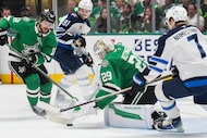 Dallas Stars goaltender Jake Oettinger (29) makes a save in front of center Sam Steel (18),...