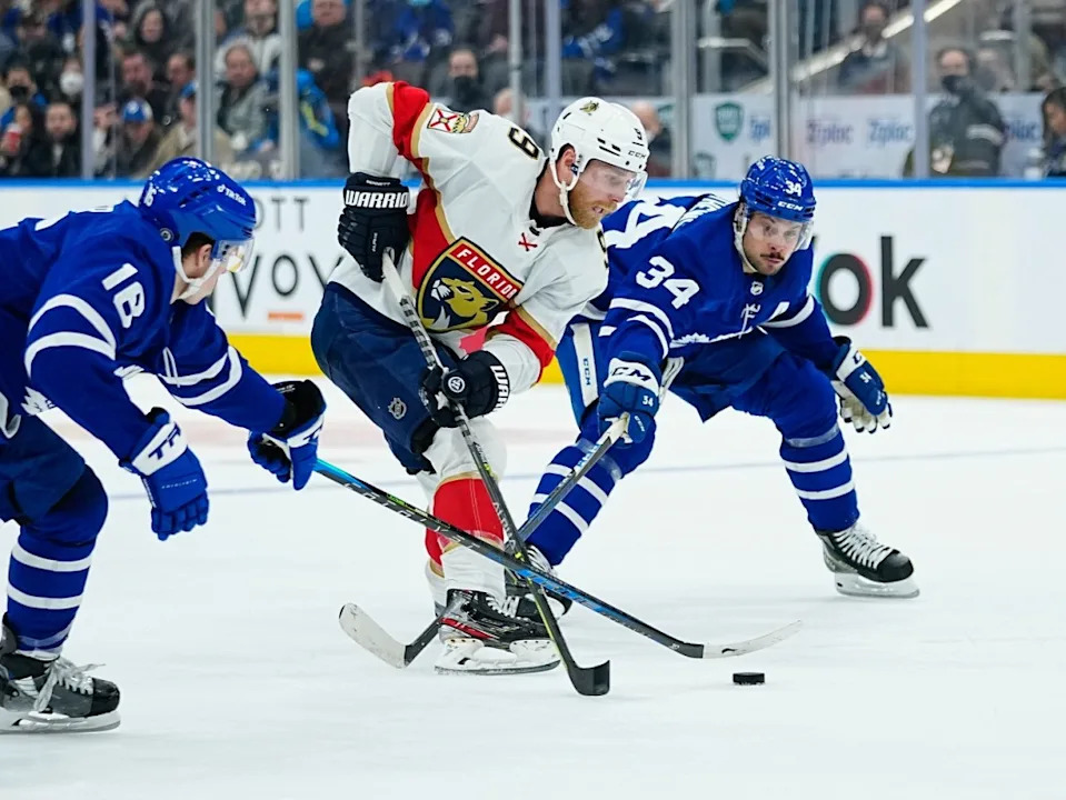 Florida Panthers forward Sam Bennett (9) tries to carry the puck between Toronto Maple Leafs forward Mitchell Marner (16) and forward Auston Matthews (34) at Scotiabank Arena. John E&period; Sokolowski-Imagn Images