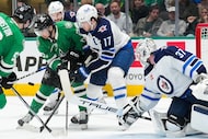 Dallas Stars center Mavrik Bourque (22) fights for the puck against Winnipeg Jets center...