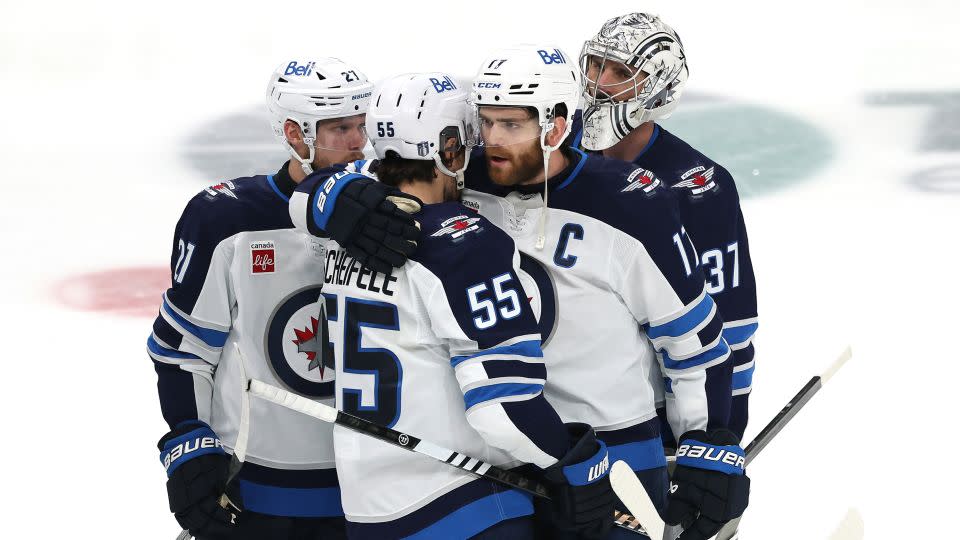 Mark Scheifele and Adam Lowry  hug after their defeat. - Sam Hodde/Getty Images