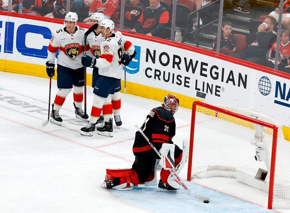 The Panthers’ Anton Lundell (15), left, and Tomas Nosek (92) celebrate with Eetu Luostarinen (27) after he scored past Carolina’s Frederik Andersen (31) during the third period of the Florida Panthers’ 5-2 victory over the Carolina Hurricanes in Game 1 of the Eastern Conference Finals at the Lenovo Center in Raleigh, N.C., Tuesday, May 20, 2025.