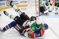 Dallas Stars' Sam Steel (18) and Edmonton Oilers' Corey Perry (90) get tangled up during...