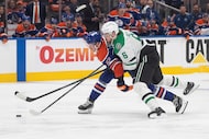 Dallas Stars' Lian Bichsel (6) and Edmonton Oilers' Trent Frederic (21) battle for the puck...
