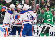 Edmonton Oilers defenseman Brett Kulak (center) celebrates with Evan Bouchard (2).  Zach...