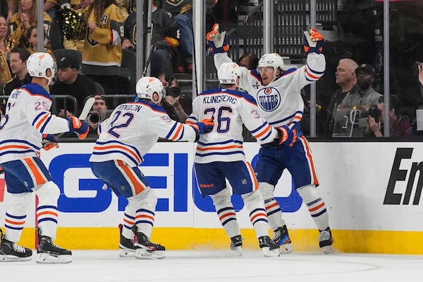 Edmonton Oilers right wing Kasperi Kapanen, right, celebrates with teammates after scoring against the Vegas Golden Knights during overtime of Game 5 of a second-round NHL hockey playoff series Wednesday, May 14, 2025, in Las Vegas. (AP Photo/John Locher)