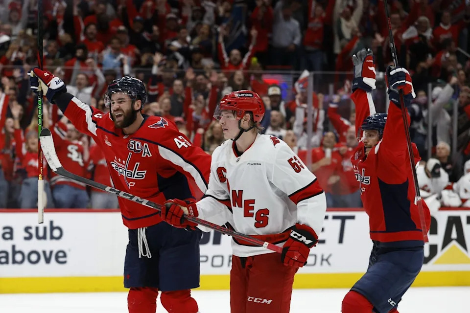 Washington Capitals right wing Tom Wilson (43) celebrates after scoring an empty net goal as Carolina Hurricanes right wing Jackson Blake (53) looks on in the third period.Geoff Burke-Imagn Images