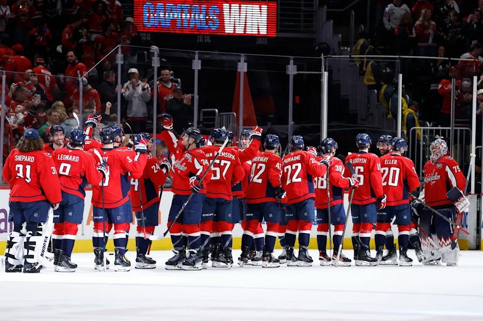 Apr 10, 2025; Washington, District of Columbia, USA; Washington Capitals players celebrate after their game against the Carolina Hurricanes at Capital One Arena. Mandatory Credit: Geoff Burke-Imagn Images